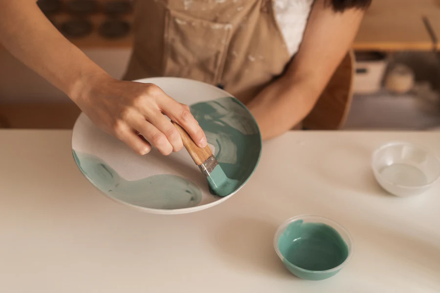 Guests painting pottery at Earth Arts Pottery Studio