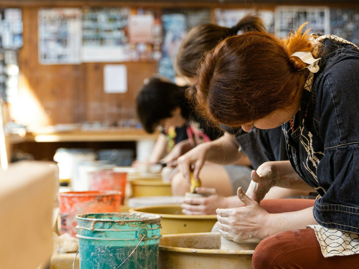 Throw Together - a row of potters at the wheel, Garden City